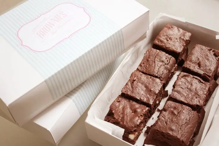 a beatiful white custom brownie box filled with 7 brownies