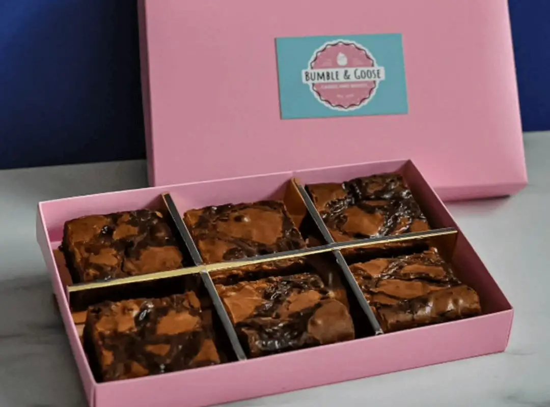 a pink custom brownie box with 6 delicious brownies